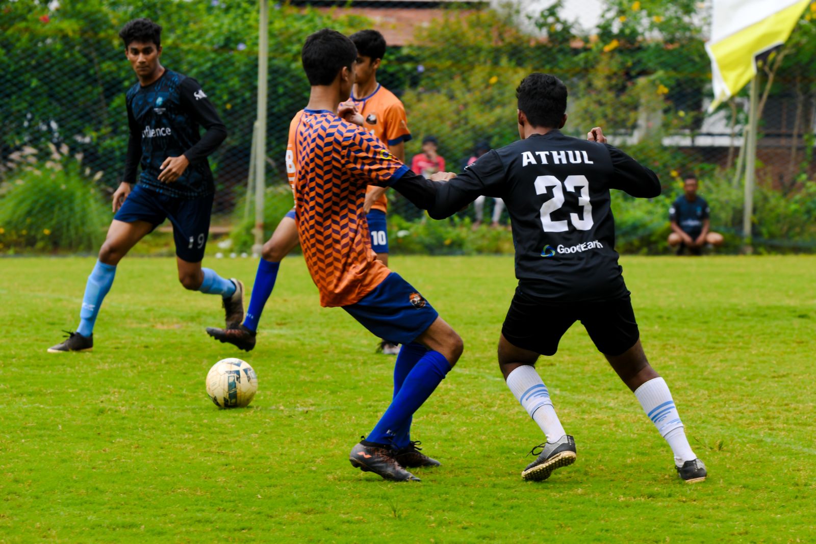 A football match with a player in a GoodEarth jersey